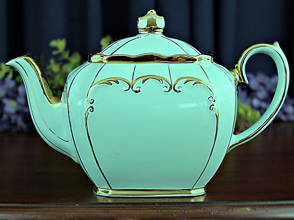 https://thevintageteacup.us/cdn/shop/products/teal-cube-teapot-by-sadler-england-full-sized-tea-pot-18257teapotsthe-vintage-teacup-129381_1024x1024.jpg?v=1684553262