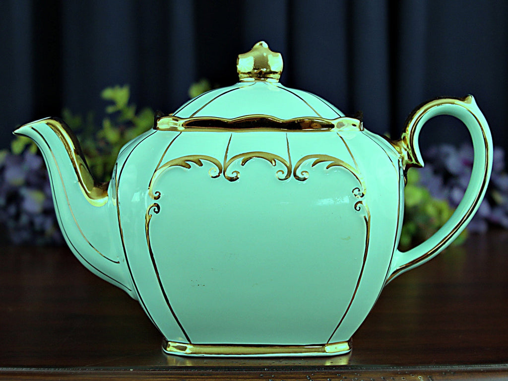 https://thevintageteacup.us/cdn/shop/products/teal-cube-teapot-by-sadler-england-full-sized-tea-pot-18257teapotsthe-vintage-teacup-715145_1024x1024.jpg?v=1684553262